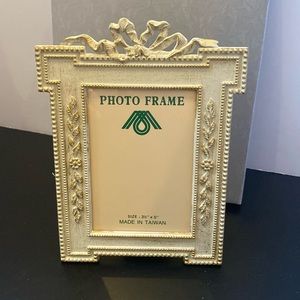 Cream color w/ goldtone trim metal frame has display stand picture size 3.5x5”